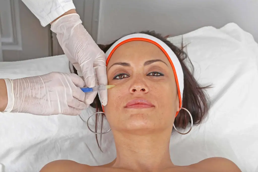 A woman getting an injection of eye fillers in Duluth, GA